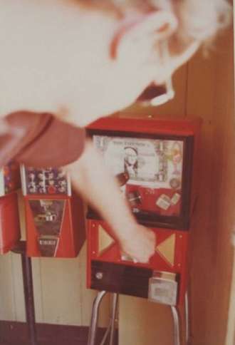 Man Reaching for Vending Machine