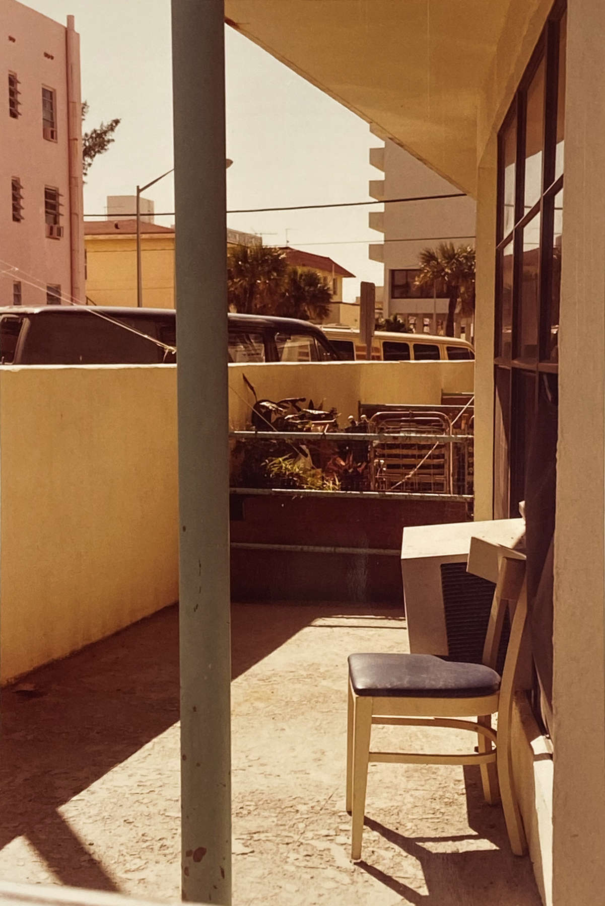 William Eggleston, Untitled (chair, pink building), c. 1980s