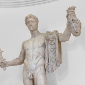 A Pentelic marble sculpture depicting the mythological story of Perseus beheading Medusa.