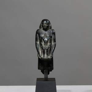 Egyptian theophorous figure, holding a seated statuette of Imhotep, Late Period, 27th-30th Dynasty, c.525-343 BC