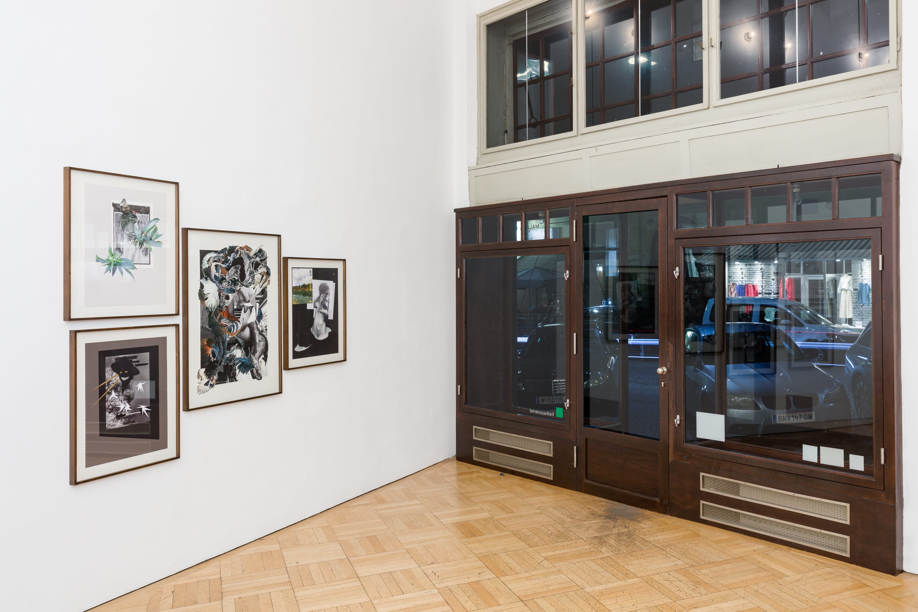 Image of a four part Marcia Kure collage installed near a glass facade in a gallery