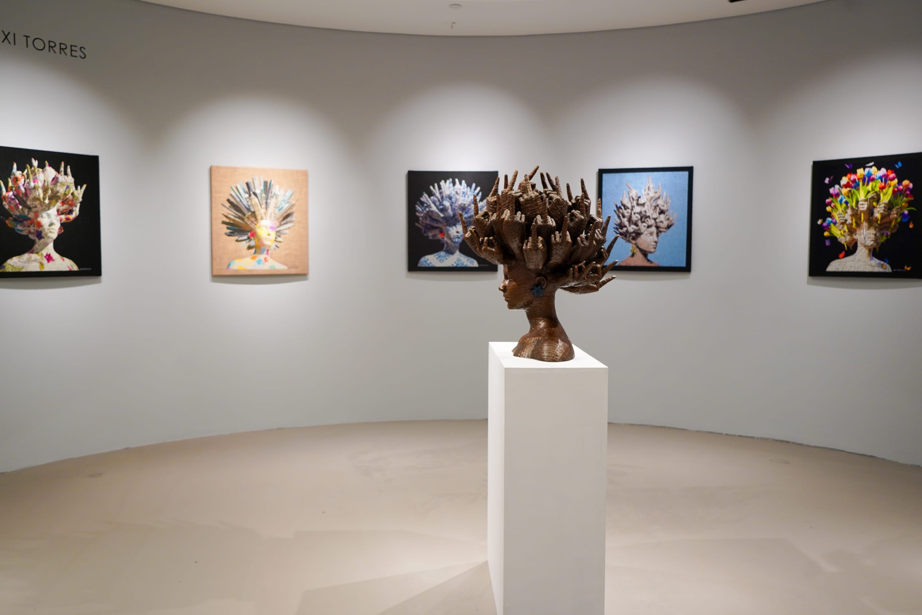 Alexi Torres bronze sculpture on display in Lenox Square's luxury wing next to Neiman Marcus, Gucci, Louis Vuitton.