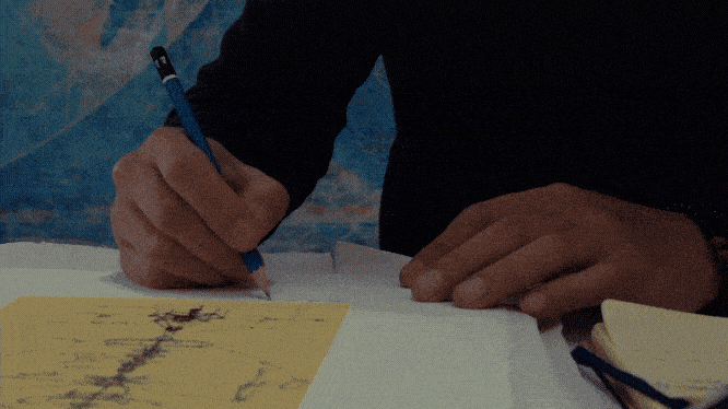 Min signing each work by hand