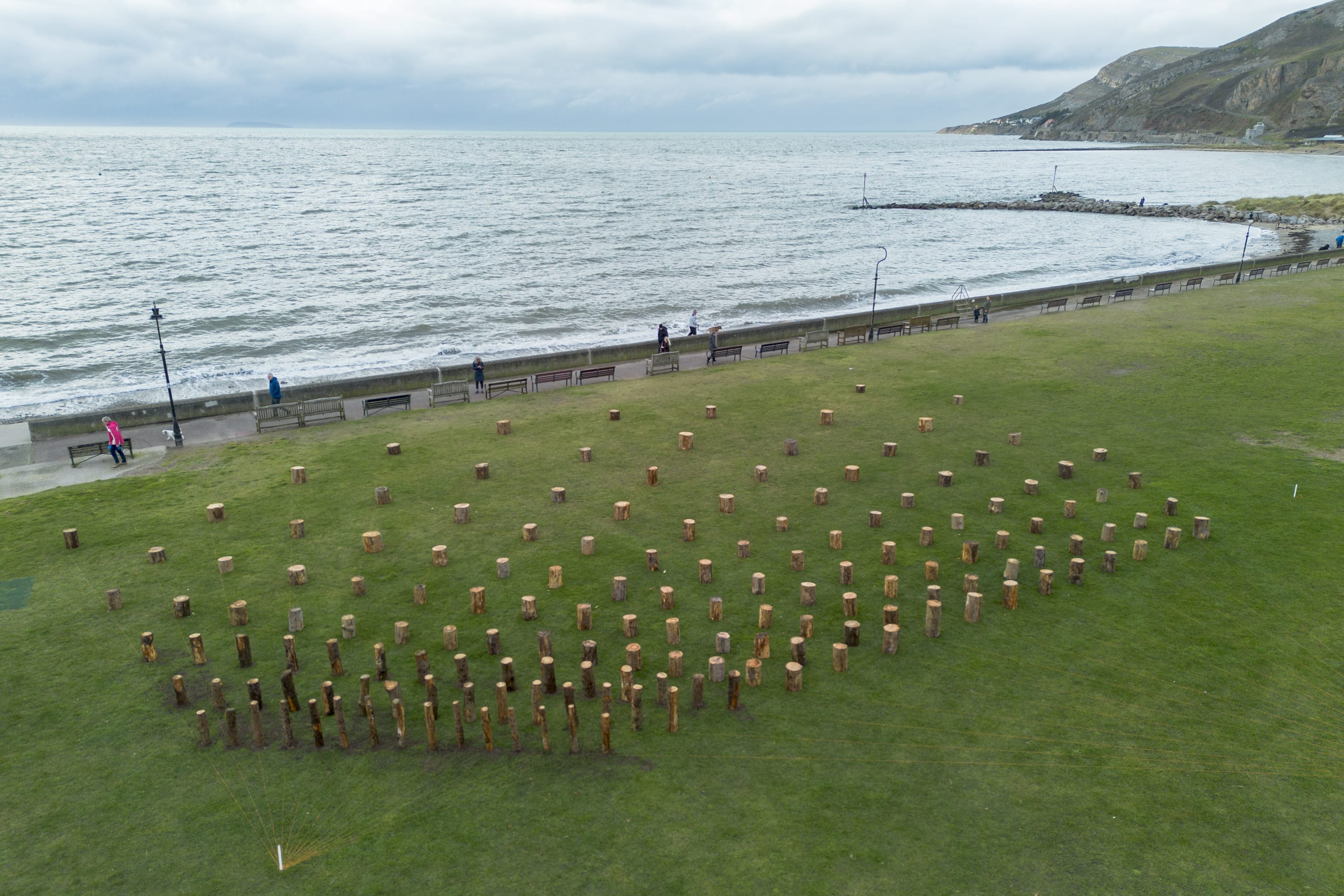 Rosemarie Castoro in The Guardian From New York to north Wales: artist’s field of logs recreated on Llandudno beach
