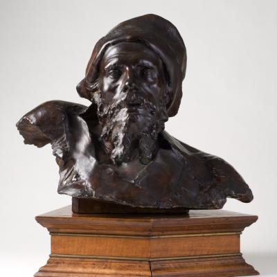 Jean-Joseph Carriès  Un Désespéré (Le Mendiant Russe), Circa 1870s  Signed: Jean Carriès; dedication inscribed on back: A Mon Ami A. Arnault  Patinated plaster with a brown patina mounted on a purpose-built period oak base designed by the artist  18 1/2 H x 20 W inches