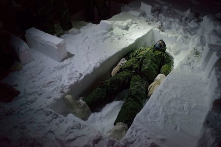 Louie Palu, A Canadian flight engineer on an Arctic Survival course at Resolute Bay, Nunavut seen lying in a trench during a lesson on cutting snow blocks. January is a month in the Arctic which sees nearly 24-hours of darkness and extreme cold and are normal conditi, 2017