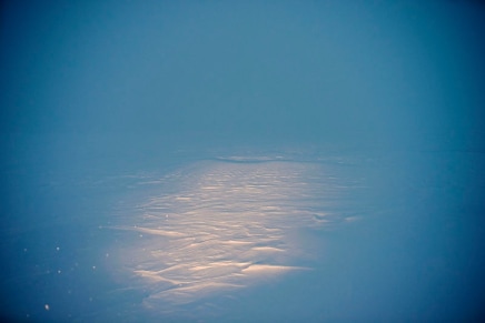 Louie Palu, The headlight from a snowmobile driven by a Canadian Ranger illuminates a treeless landscape in a snowstorm during a Type 1 Patrol and caribou hunt several hours outside Gjoa Haven, King William Island, Nunavut, 2017