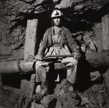 Louie Palu, Miner sitting on timber at an ore chute underground at the Kerr Mine, Virginiatown, Ontario, Canada, 1994