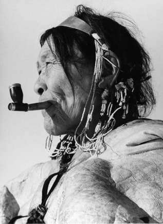 Richard Harrington, ["Eegie" A Padleimiut Inuit Woman in her Best Finery smoking a pipe], 1950