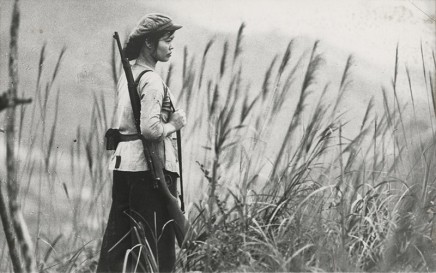 Photographer Unknown, [North Vietnamese soldier Nguen Thi-Hai stands guard], circa 1965