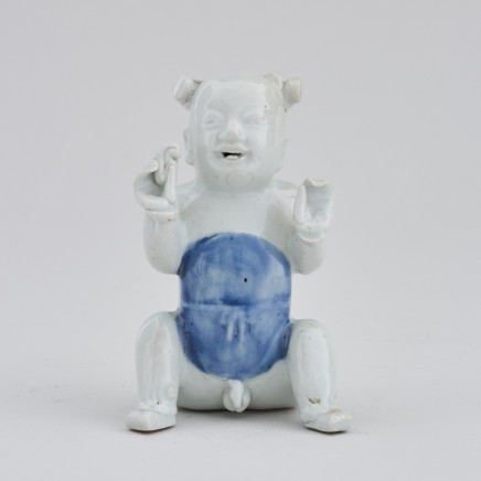 A CHINESE EXPORT MODEL OF A SEATED BOY, first half of the 18th century or earlier