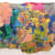 A collaged fabric banner with yellow, blue, and pink overlapping shapes