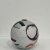 Ceramic artwork by Adam Frew featuring abstract patterns with shades of white, maroon, and grey on a spherical form.