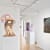 Exhibition view of Moon Walk at Buysse Gallery, showing a biomorphic sculpture by Leo Orta on a pedestal and surreal landscape paintings by Silvia Giordani on white gallery walls.