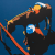 Jeremy Booth painting with a cowboy and a horse on blue background.