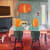 painting of two identical female figures with orange hair sitting at a table in a room with a dog