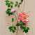 detail of pink flowers with green leaves and stems with subtle dog faces