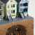 miniature sculpture of 3 victorian houses with a hole underground