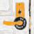 Painting of a yellow doorknob with a door tag on it that reads "do not disturb" on a white door by Michael McGregor.