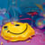 Megan Ellen MacDonald painting of deflated yellow happy face balloon