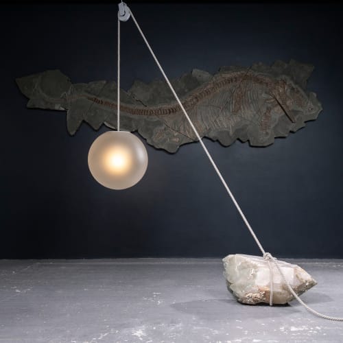 Jesse Visser  Beacon of Light. Madagascar Quartz, 2023  Unique Madagascar quartz boulder (28x69x37cm), sandblasted glass D50, natural rope, steel pulley  50 x 50 x 50 cm  19 ¾ x 19 ¾ x 19 ¾ in  Unique