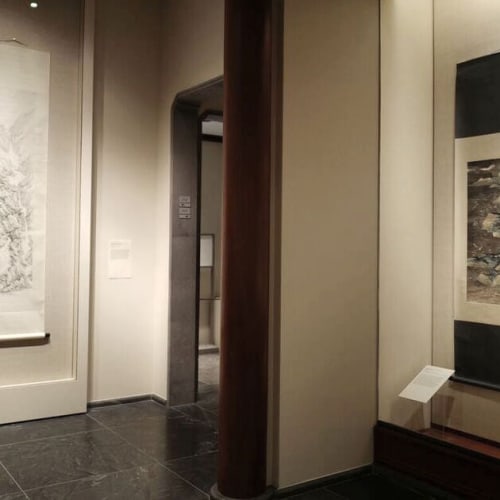 On the left is hanging a landscape scroll with lines by arnold, and on the right is hanging a work by c.c.wang