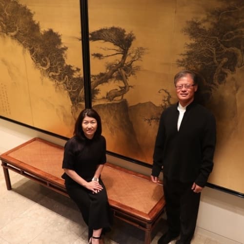 Akiko Yamazaki  was sitting on the left and Jerry Yang standing on the right side, a screen behind them