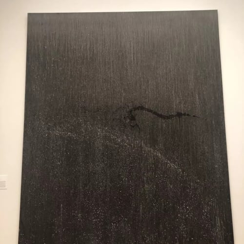 black painting hanging on the wall