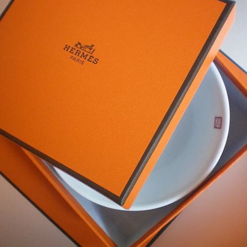 An orange box with a white plate inside