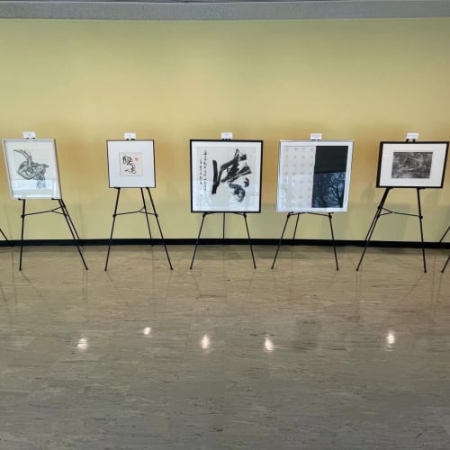 seven artworks exhibiting on tripod stands