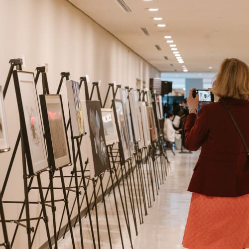 A person taking a picture of a Exhibition