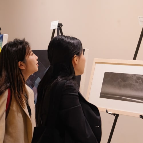 A couple of women looking at a picture