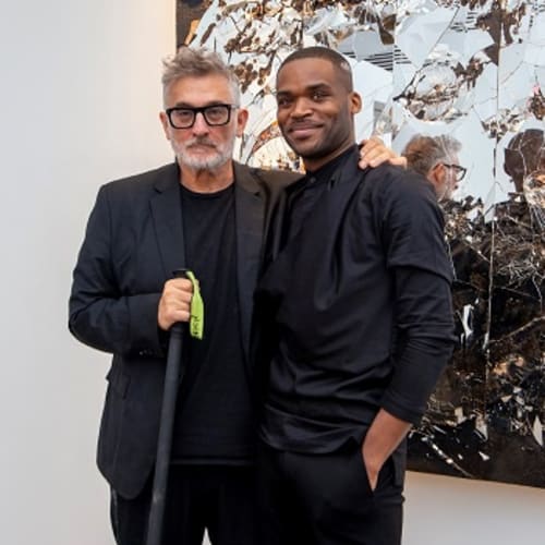 Featured artist Michael David poses with Bill Lowe Gallery director Donovan Johnson.