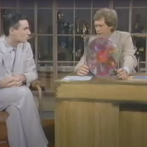 David Byrne (l) explaining Robert Rauschenberg's album design to David Letterman (r). 1983