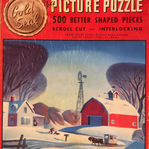 Dale Nichols work on a Gold Seal picture puzzle.