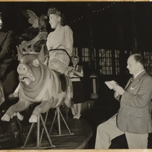 Reginald Marsh sketching a couple on a merry-go-round, 193- Gene Pyle, photographer Reginald Marsh papers, Archives of American Art, Smithsonian Institution