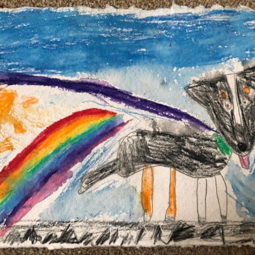 A child's drawing of a dog in a colourful superhero cape with a rainbow