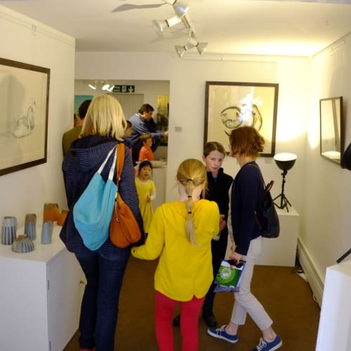 Some children and their families are looking at the art on display at Sarah Wiseman Gallery