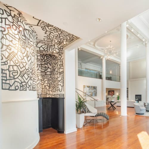 An 8,000 square foot triplex loft has been converted to a private residence, with the original mural intact.