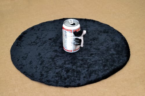 Audie Murray Bud, Tobacco & Spider, 2021 Budweiser beer can, silver thread, tobacco bundle, black velvet 5 x 18 1/2 x 18 1/2 inches 12.7 x 47 x 47 cm