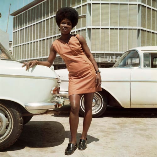 James Barnor Sick Hagemeyer shop assistant as a seventies icon posing in front of the United Trading Company headquarters, Accra, 1971 Modern C-Print from original negative Sold out Edition of 5 plus 2 artist's proofs