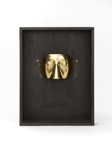Man Ray Optic Topic Mask, conceived in 1974, executed 1978 Gold plated sterling silver & brown suede cord with original wood frame marked 'Optic Topic'. mask: 13 x 8 x 6 cm frame: 37 x 28 x 7.5 cm edition of 100 executed by GEM - Montebello Signed with certificate of authenticity.