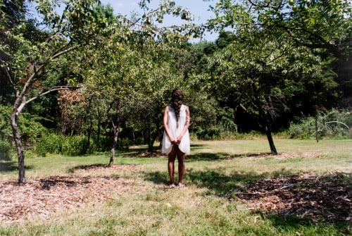 Allison Janae Hamilton, Dollbaby standing in the orchard at midday (from the series, "Sweet milk in the badlands"), 2015