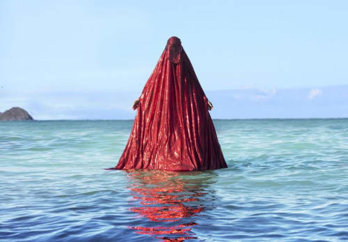 Anida Yoeu Ali, ‘Water Birth, The Red Chador: Genesis I’ (2019), Kaiona Beach, Oahu, USA