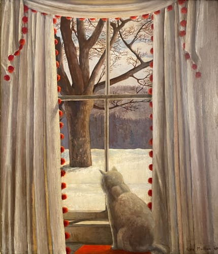 cat looking out the window at a tree in the snow