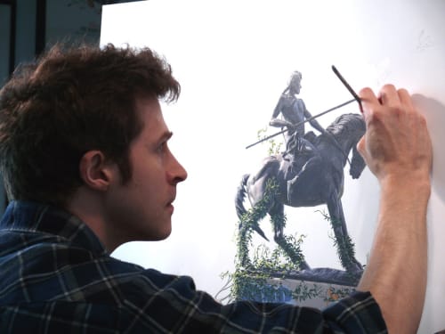 portrait of artist Josh Keyes painting horse and rider