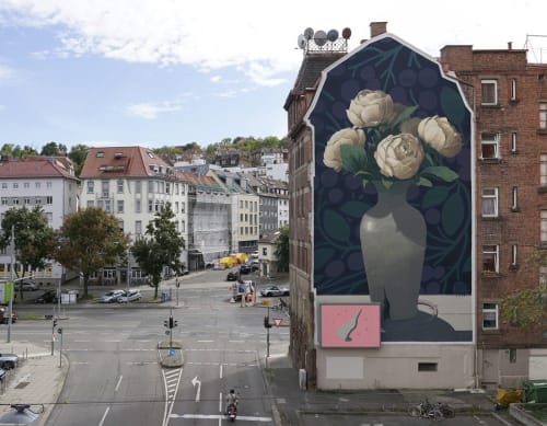 large scale Bezt mural of broken vase; city in background