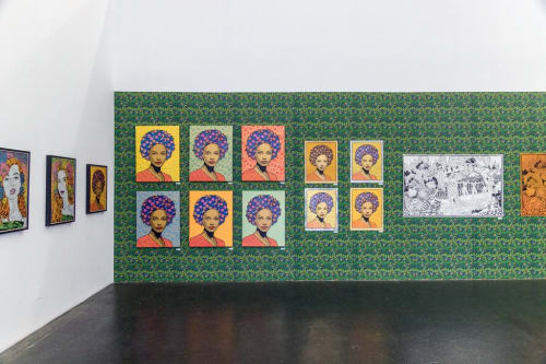 Chuck Sperry prints hung on a green wall