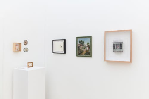 Install photo of framed illustrations by Petite Luxures hung on a wall