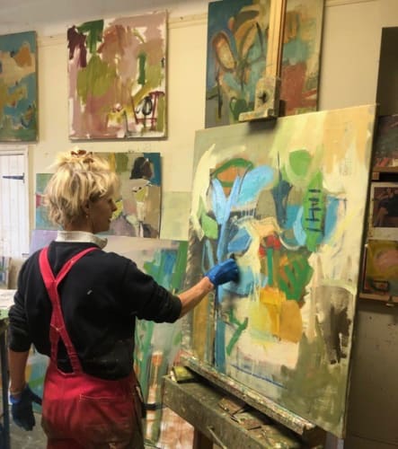 Chloë Lamb painting in her studio